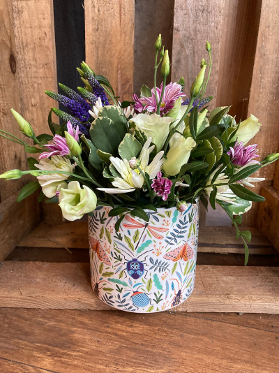 Dragonfly - Beautiful seasonal flowers arranged in a ceramic pot.