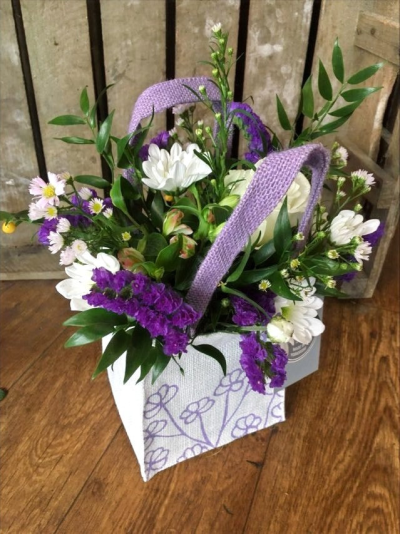 Flower Pop - A beautifully arranged selection of lilac and purple flowers arranged in foam and presented in a hessian bag

 

Each and every display is one-of-a-kind, created by an artisan florist using the most beautiful and fresh stems available on the day so, whilst your gift may look different to the one pictured, we do guarantee that your specific arrangement will be fresh, beautiful and that your recipient will love it!