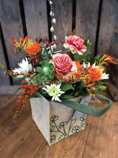 Bags of Fun - A vibrant selection of Autumnal flowers in orange shades, arranged in foam and presented in a Hessian bag

 

Each and every display is one-of-a-kind, created by an artisan florist using the most beautiful and fresh stems available on the day so, whilst your gift may look different to the one pictured, we do guarantee that your specific arrangement will be fresh, beautiful and that your recipient will love it!