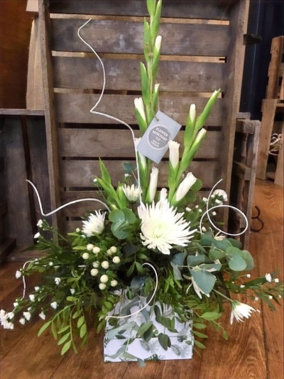 Dusk - An elegant selection of white and green flowers together with beautiful foliage, arranged in foam and presented in a hat box.

 

Each and every display is one-of-a-kind, created by an artisan florist using the most beautiful and fresh stems available on the day so, whilst your gift may look different to the one pictured, we do guarantee that your specific arrangement will be fresh, beautiful and that your recipient will love it!