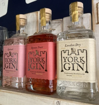 York Gin - To make York Gin, we use the traditional, centuries-old method of vapour infusion in a copper still.

Pure alcohol (made from Yorkshire grain) is heated in a copper still (essentially a very large kettle) to become a vapour. This vapour passes through a large basket of carefully chosen botanicals (herbs and spices which must, by law, include juniper berries). During the process, the alcohol takes on their flavours.

In addition, the York Gin distillery is run on sustainable principles, using 100% green energy to power the still.

London dry 70cl 42.5%
Chocolate Orange limited edition 70cl 42.5% 
Old tom 70cl 42.5% 
Grey Lady 70cl 42.5%
Outlaw 50cl 57% 
Roman Fruit 70cl 42.5%