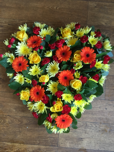 Loose Heart - Heart shaped funeral tribute in mixed flowers and colours.

Please note the heart can be made in any colours of your choice